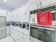 A kitchen featuring white cabinets, stainless steel appliances, and a tiled backsplash at 3911 Auburndale Ave, Orlando, FL 32839