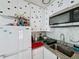 Cozy kitchen featuring white cabinetry, granite countertops, and stainless steel microwave at 3911 Auburndale Ave, Orlando, FL 32839