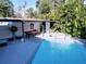 Pool and covered patio featuring an outdoor billiards table and waterfall at 3911 Auburndale Ave, Orlando, FL 32839