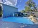 Exterior view of the pool with a waterfall feature, outdoor lounging and home exterior at 3911 Auburndale Ave, Orlando, FL 32839