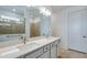 Modern bathroom featuring double sinks, white cabinets, and a large mirror, complemented by a tiled shower at 5295 Sw 87Th Ter, Ocala, FL 34481