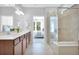 Modern bathroom featuring double vanities and a glass-enclosed shower at 5295 Sw 87Th Ter, Ocala, FL 34481