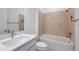 Contemporary bathroom with tiled shower over tub, vanity sink, and neutral color palette at 5295 Sw 87Th Ter, Ocala, FL 34481
