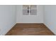 Empty bedroom showcasing hardwood floors, white walls and trim, and a bright window at 5295 Sw 87Th Ter, Ocala, FL 34481