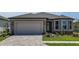 Charming single-story home with a paved driveway, well-maintained lawn, and neutral-colored stucco at 5295 Sw 87Th Ter, Ocala, FL 34481