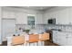 Bright kitchen features white cabinets, quartz countertops, stainless steel appliances, and a tile backsplash at 5295 Sw 87Th Ter, Ocala, FL 34481