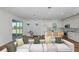 Bright living room featuring an open floor plan that connects the kitchen and dining area at 5295 Sw 87Th Ter, Ocala, FL 34481