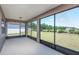 Screened patio offering scenic views of the expansive backyard and lush greenery at 5295 Sw 87Th Ter, Ocala, FL 34481