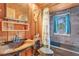 Rustic bathroom featuring a unique sink, bathtub, and wood accents at 114 Tempsford Rd, Auburndale, FL 33823