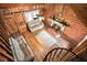 High angle view of living room with stone fireplace and spiral staircase at 114 Tempsford Rd, Auburndale, FL 33823