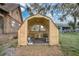 Open shed with wooden construction and a concrete floor, great for storage or workshop space at 114 Tempsford Rd, Auburndale, FL 33823