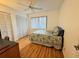 Bedroom features laminate floors, closet, and a ceiling fan at 200 Lemon Tree Ln # A, Ormond Beach, FL 32174