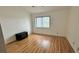 Bright bedroom features a window, sleek laminate flooring, and ceiling fan at 200 Lemon Tree Ln # A, Ormond Beach, FL 32174