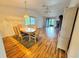 Open dining area adjacent to a living area with hardwood floors and contemporary lighting at 200 Lemon Tree Ln # A, Ormond Beach, FL 32174