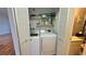 Closet laundry with stacked washer and dryer located next to bathroom at 200 Lemon Tree Ln # A, Ormond Beach, FL 32174