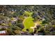 Scenic view of a golf course winding through a neighborhood with lush trees and well-kept lawns at 2450 Shelby Ln, Clermont, FL 34711