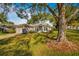 Well-maintained home featuring mature trees and landscaping, and an attached two car garage at 2450 Shelby Ln, Clermont, FL 34711