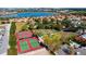 Aerial view of a community featuring tennis courts, basketball court, park and a beautiful lake at 2450 Shelby Ln, Clermont, FL 34711