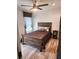 Cozy bedroom with wood platform bed and light brown flooring at 309 Burrowing Owl Ln, Winter Haven, FL 33880