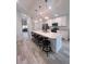 Modern kitchen with white cabinets, a large island, and stainless steel appliances at 309 Burrowing Owl Ln, Winter Haven, FL 33880