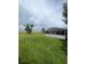 View of backyard and screened pool area with ample space for outdoor activities at 331 Marquee Dr, Kissimmee, FL 34758
