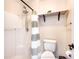 Clean bathroom offering a shower, toilet, shelving for storage and bright light at 331 Marquee Dr, Kissimmee, FL 34758