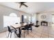 Bright dining area showcasing a ceiling fan, tile flooring, and a modern dining table set for six at 331 Marquee Dr, Kissimmee, FL 34758