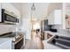 Bright kitchen featuring stainless steel appliances, white cabinets and a double basin sink at 331 Marquee Dr, Kissimmee, FL 34758