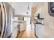 Bright kitchen with stainless steel appliances, white cabinetry, and tile flooring, perfect for cooking and entertaining at 331 Marquee Dr, Kissimmee, FL 34758