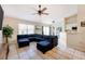 Relaxing living room featuring tile flooring, ceiling fan, and neutral color palette at 331 Marquee Dr, Kissimmee, FL 34758