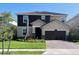 Charming two-story home boasts a two-car garage, well-kept lawn, and is attractively landscaped at 4446 Shiva Loop, Kissimmee, FL 34746