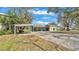 Open backyard with a barbeque shelter and an expansive parking area at 506 Parrott Rd, Auburndale, FL 33823