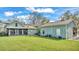 Lush green backyard featuring a screened-in porch, a well, and detached garage at 506 Parrott Rd, Auburndale, FL 33823