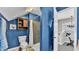 Vibrant blue bathroom with a walk-in shower, toilet, and plenty of storage space at 506 Parrott Rd, Auburndale, FL 33823