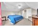 Well-lit bedroom featuring a ceiling fan, chair and large bed at 506 Parrott Rd, Auburndale, FL 33823