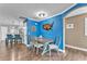 Dining area with blue accent wall, wood floors, and view of the kitchen at 506 Parrott Rd, Auburndale, FL 33823