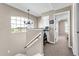 Hallway with railing and chandler with bedrooms on either side at 506 Parrott Rd, Auburndale, FL 33823