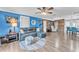 Living room with blue walls, wood flooring, and stylish leather furniture at 506 Parrott Rd, Auburndale, FL 33823