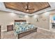 Beautiful main bedroom featuring a decorative wood plank ceiling, carpet floors and a king bed at 506 Parrott Rd, Auburndale, FL 33823