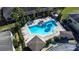 Aerial view of the community pool with lounge chairs and palm trees at 5409 Limestone Ln, Lakeland, FL 33809