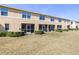 Exterior view of home with back patio and lush, green backyard at 5409 Limestone Ln, Lakeland, FL 33809