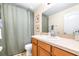 Bathroom featuring vanity, sink, toilet and shower with framed botanical prints on the wall at 5409 Limestone Ln, Lakeland, FL 33809