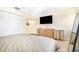 Bedroom featuring a spacious closet, dresser with television, and neutral-toned decor at 5409 Limestone Ln, Lakeland, FL 33809