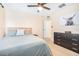 Bedroom featuring a queen bed, ceiling fan and large dresser at 5409 Limestone Ln, Lakeland, FL 33809