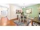 Cozy dining space with a round table, elegant chandelier, decorative wall mirror, and hardwood floors at 5409 Limestone Ln, Lakeland, FL 33809