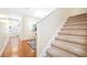 Inviting entryway featuring wood floors and carpeted stairs at 5409 Limestone Ln, Lakeland, FL 33809