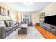 Bright living room with neutral walls, modern furniture, and a large area rug at 5409 Limestone Ln, Lakeland, FL 33809