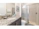 Clean bathroom with granite vanity and a glass shower at 7705 Fairfax Dr, Kissimmee, FL 34747