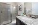 Clean bathroom with granite countertop, modern vanity, and a glass shower at 7705 Fairfax Dr, Kissimmee, FL 34747