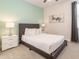 Cozy bedroom featuring a queen bed, modern art, and soothing color palette at 7705 Fairfax Dr, Kissimmee, FL 34747